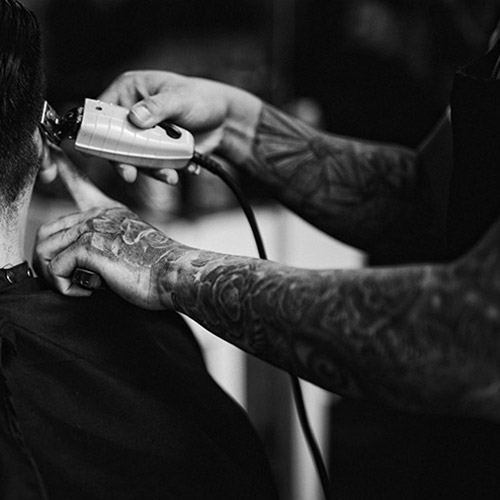 Tattooed barber cutting hair