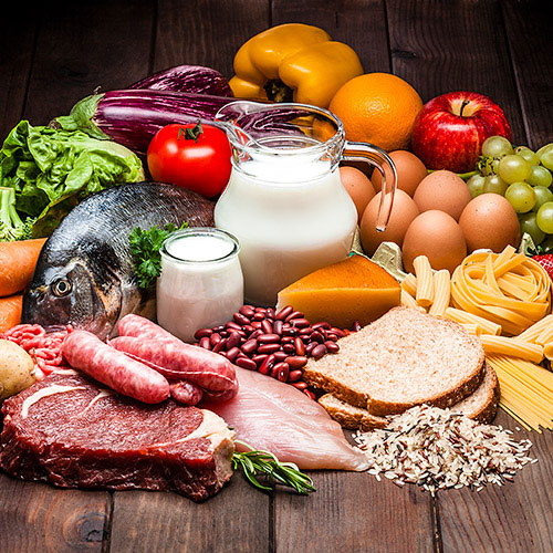 Buffet of meats and vegetables on wooden table