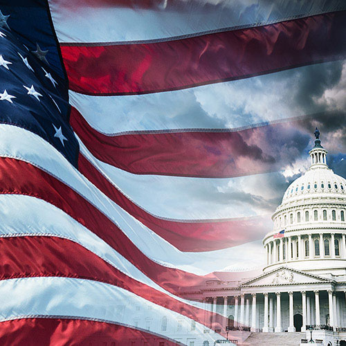 US Flag and state capitol building